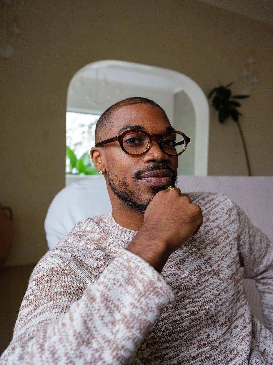 Hart, LMFT — founder of Hart to Human, seated in a warm-toned therapy office