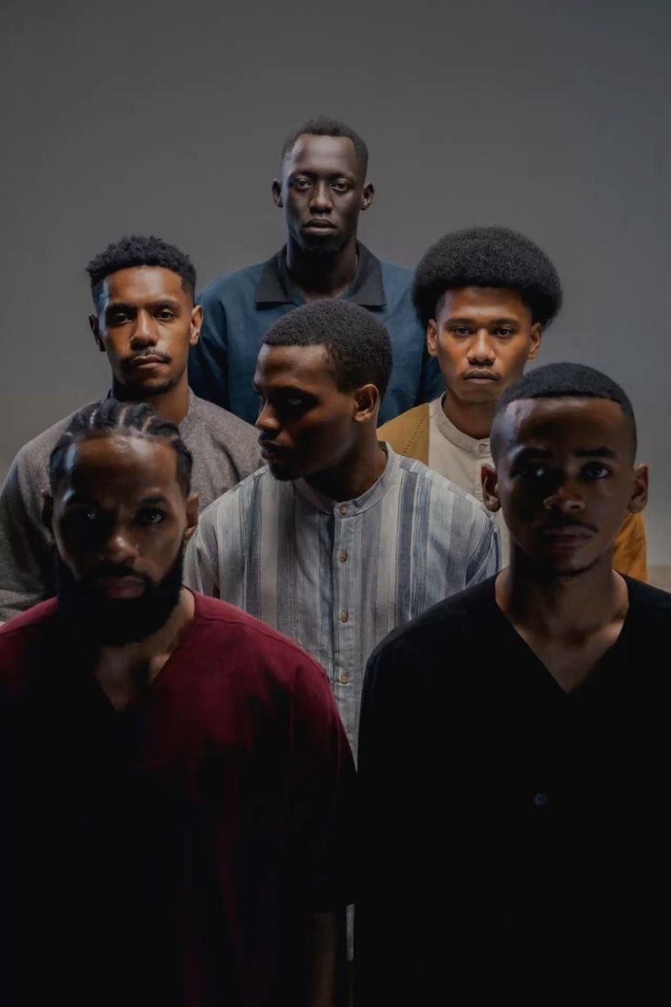 Men gathered in a reflective group wellness session